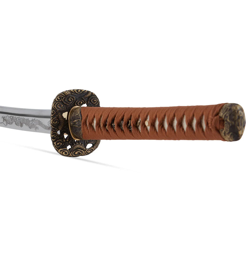 Close-up of a katana with a brown-wrapped handle, ornate dragon-themed guard, and an engraved blade against a white background.