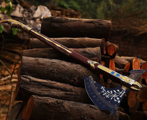 An ornate Viking-style battle axe with gold and blue engravings resting on a stack of logs.