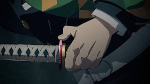 Close-up of a hand gripping a katana hilt with a colorful guard, preparing to draw the blade, in an anime scene.