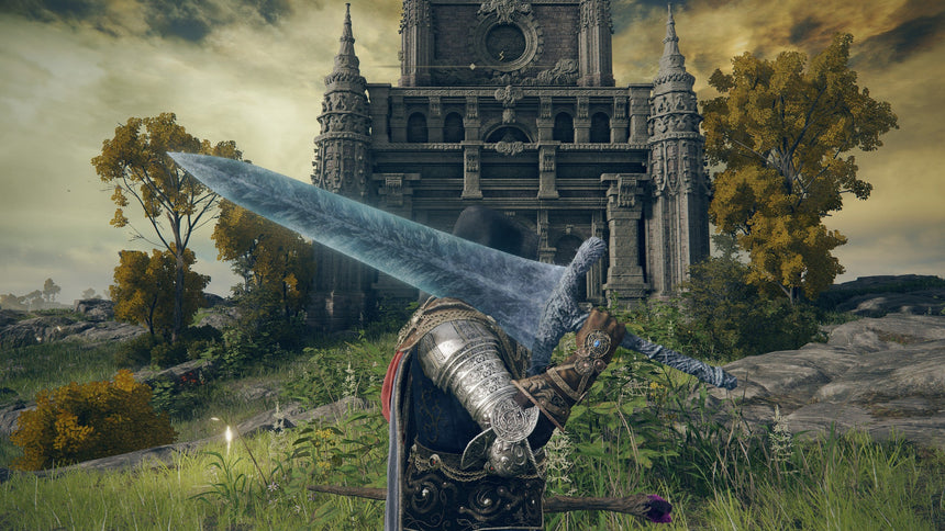 An Elden Ring gameplay screenshot of an armored character wielding a massive glowing blue greatsword in front of a towering gothic stone castle.