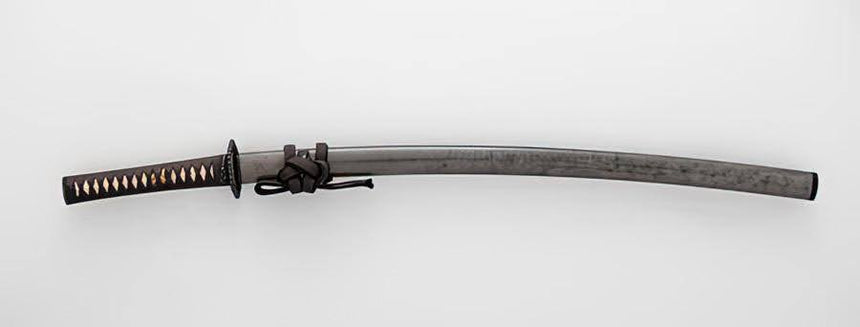 A curved katana with a dark steel blade, black wrapped handle with gold accents, and a tied cord near the guard.