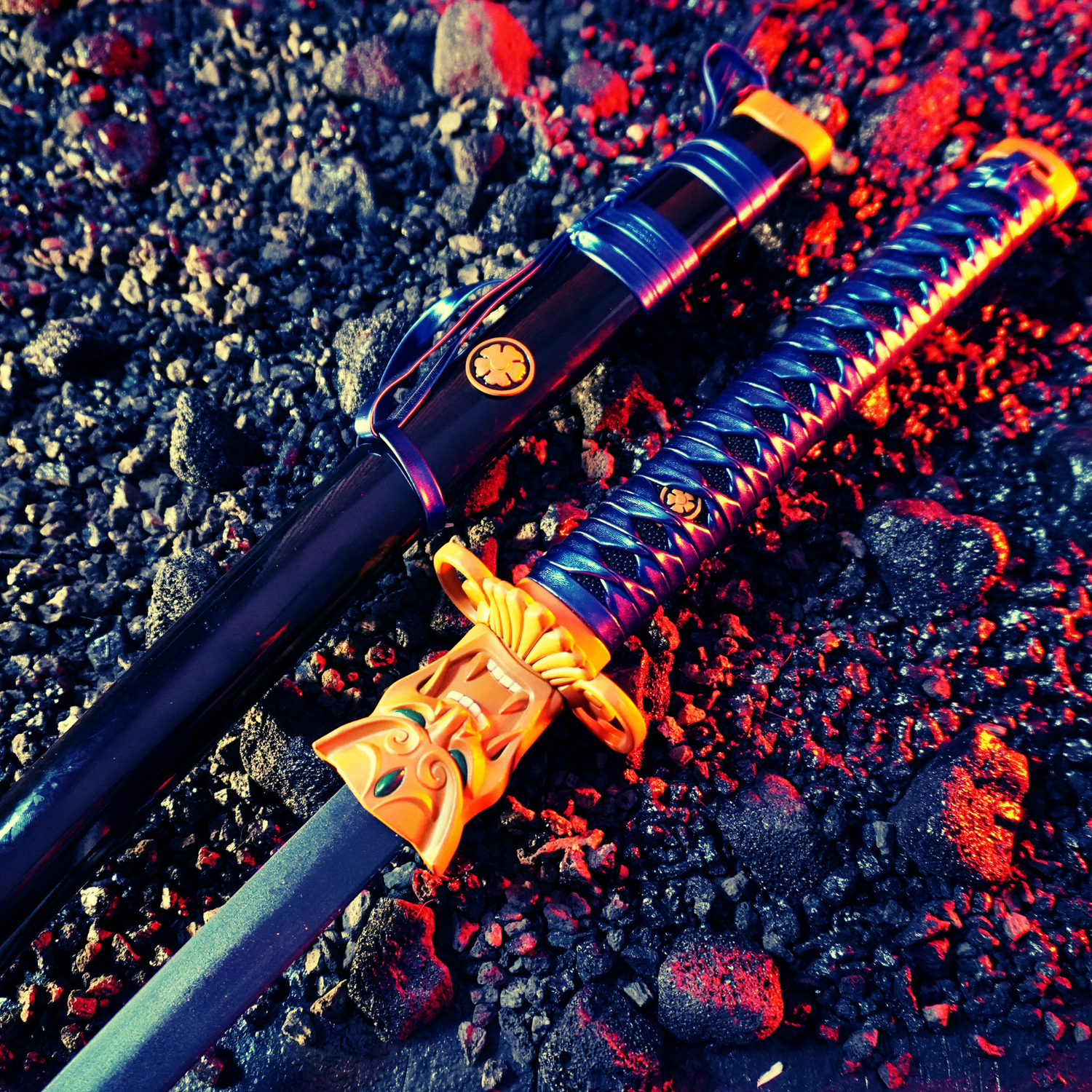 A black-and-gold katana on volcanic rocks under red-blue lighting.