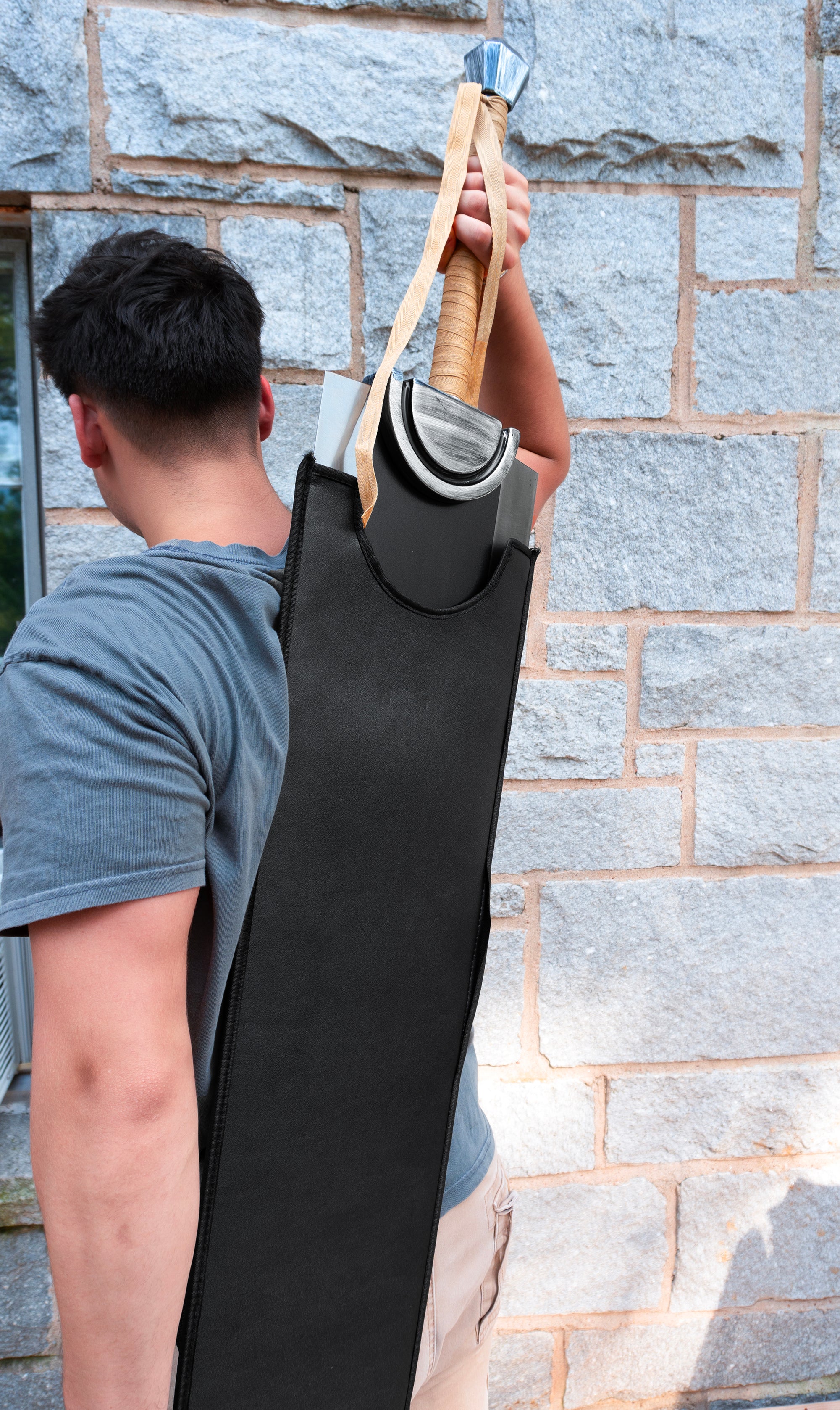 Man Holding Guts sword from Berserk