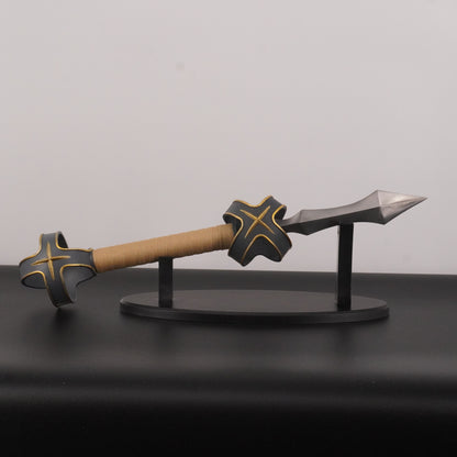Decorative axe and sickle on a stand against a gray background