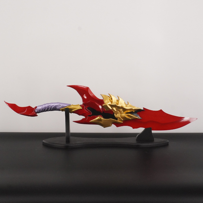 Red and gold weapon model on a stand against a gray background