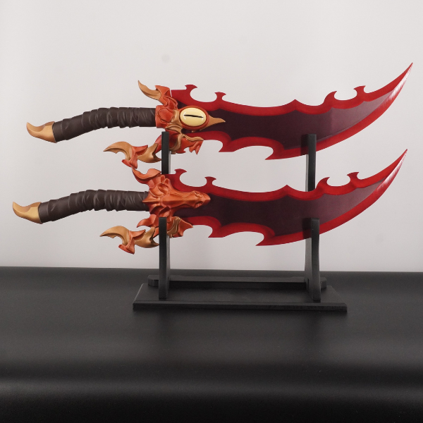 Decorative sword with red blade and brown handle on a stand against a light gray background