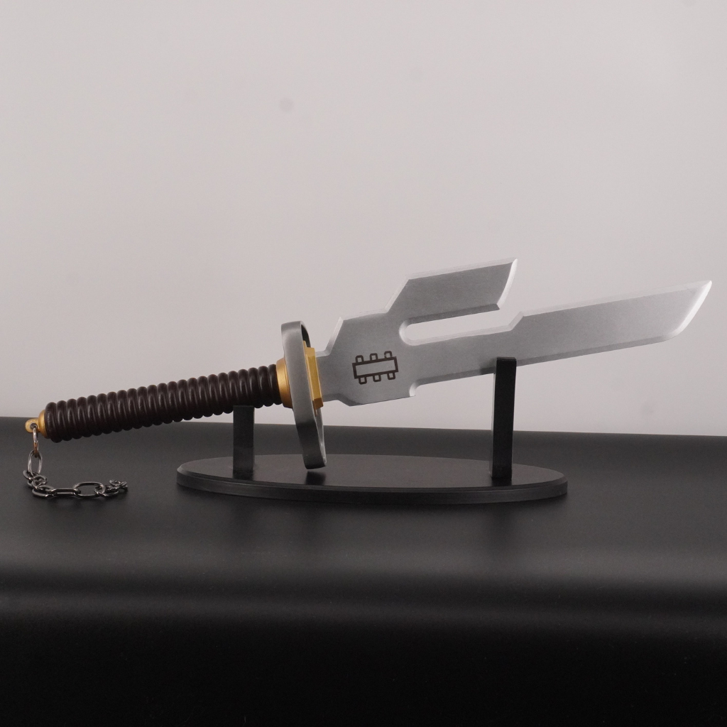 Decorative sword with a stand on a dark surface against a light gray background