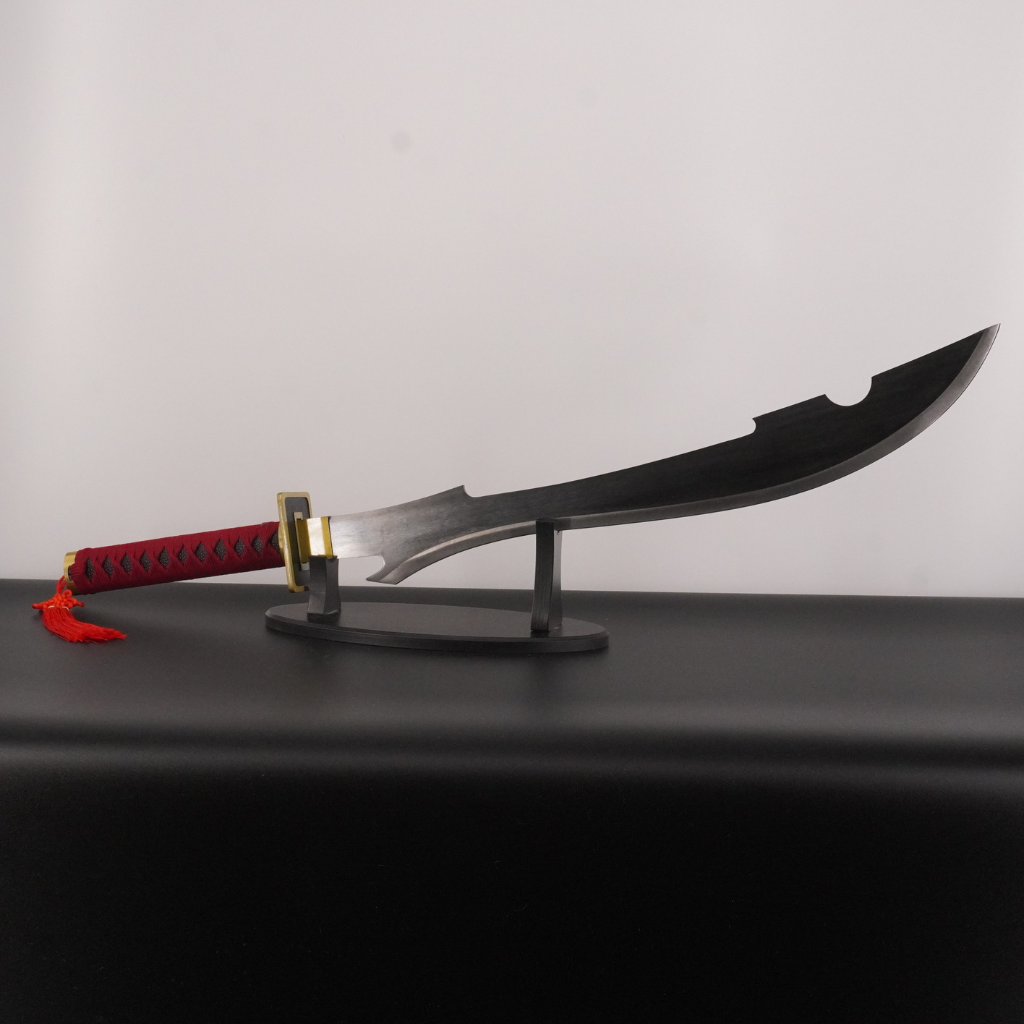 Sword with a red handle on a black stand against a gray background