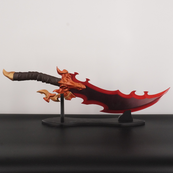 Red and black fantasy sword on a stand against a plain background
